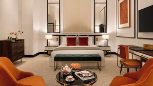 A hotel room with a bed, bedside tables, a desk, a chair, a coffee table, and a television. - Eurostars The Chemists’ Club Hotel (New York)