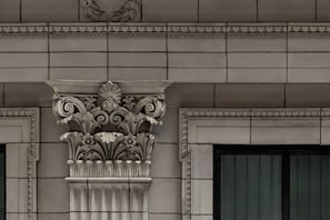 A detailed architectural column with ornate carvings and a classical design. - Eurostars The Chemists’ Club Hotel (New York)