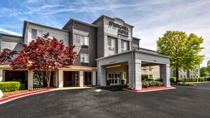 A hotel with a modern design, featuring a prominent entrance and signage for 'Springhill Suites by Marriott'.