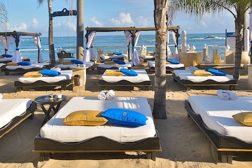 On the beach, white sand, sun loungers, beach umbrellas