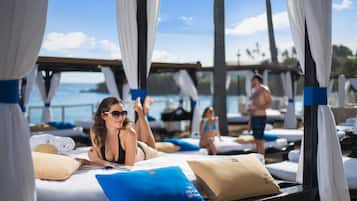 On the beach, white sand, sun loungers, beach umbrellas