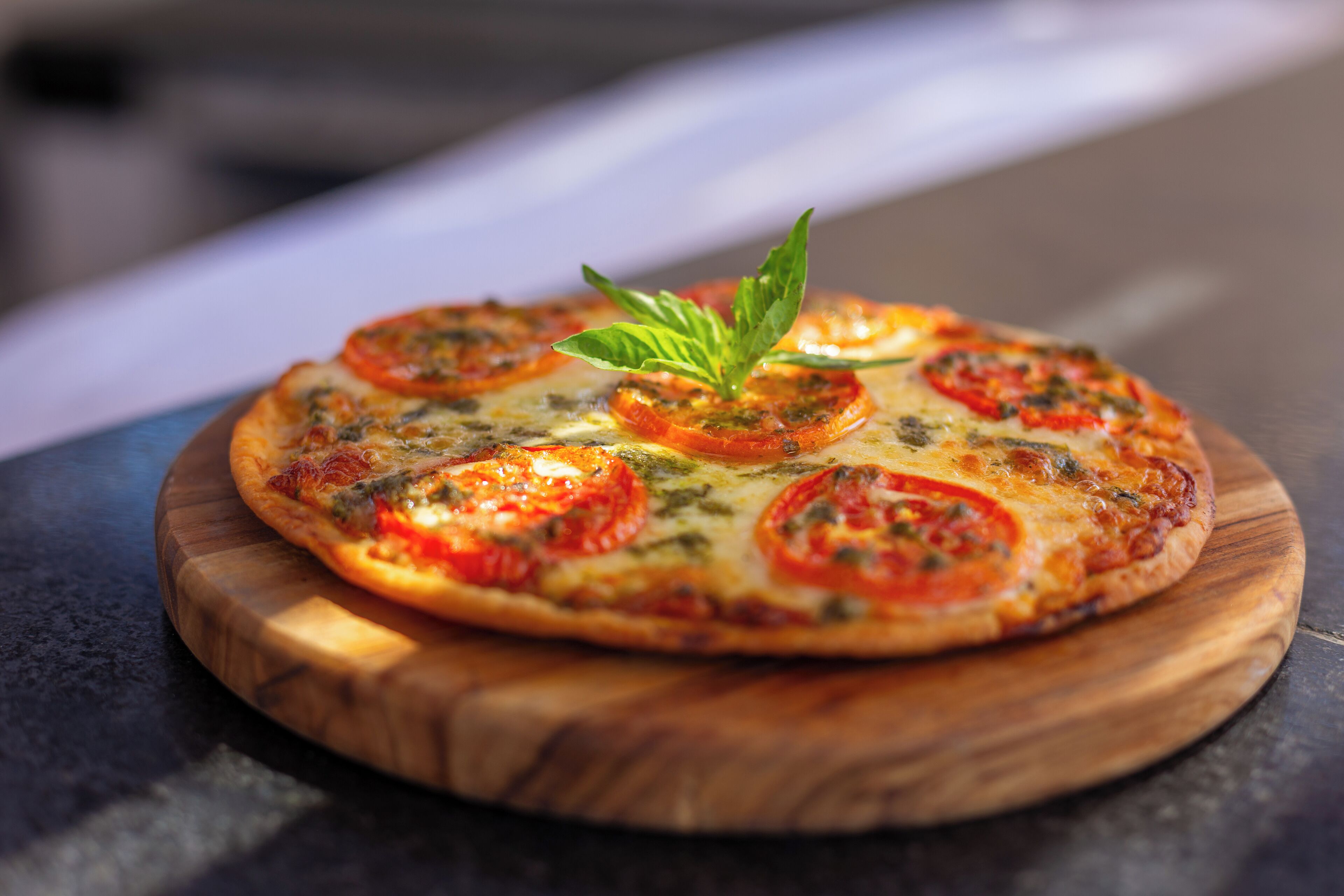 A pizza on a wooden board.