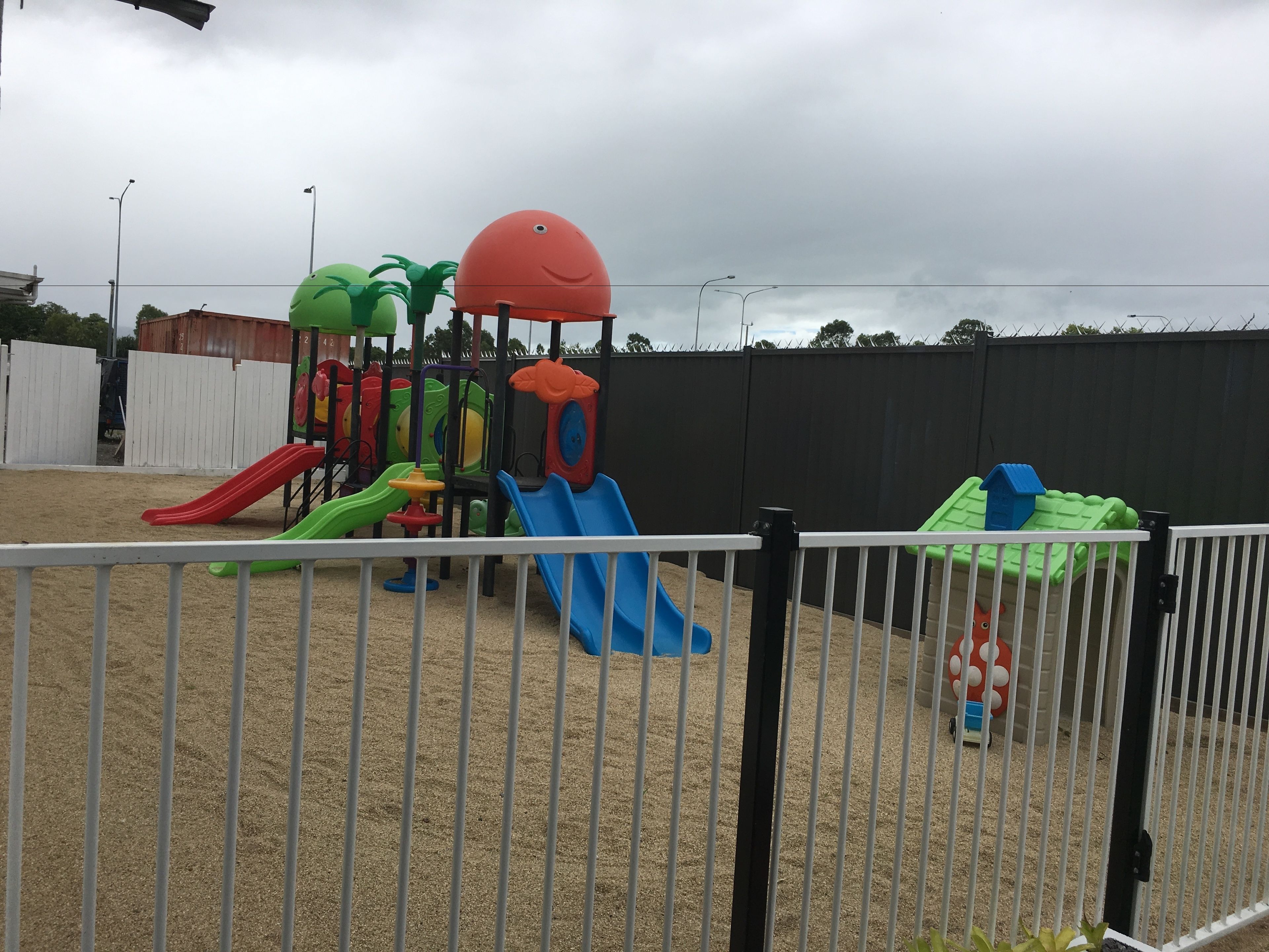 A playground with multiple slides and climbing structures.