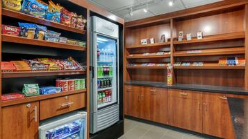 A snack and beverage section with shelves stocked with various snacks and a refrigerated display.