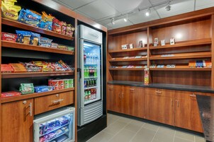 A snack and beverage section with shelves stocked with various snacks and a refrigerated display.