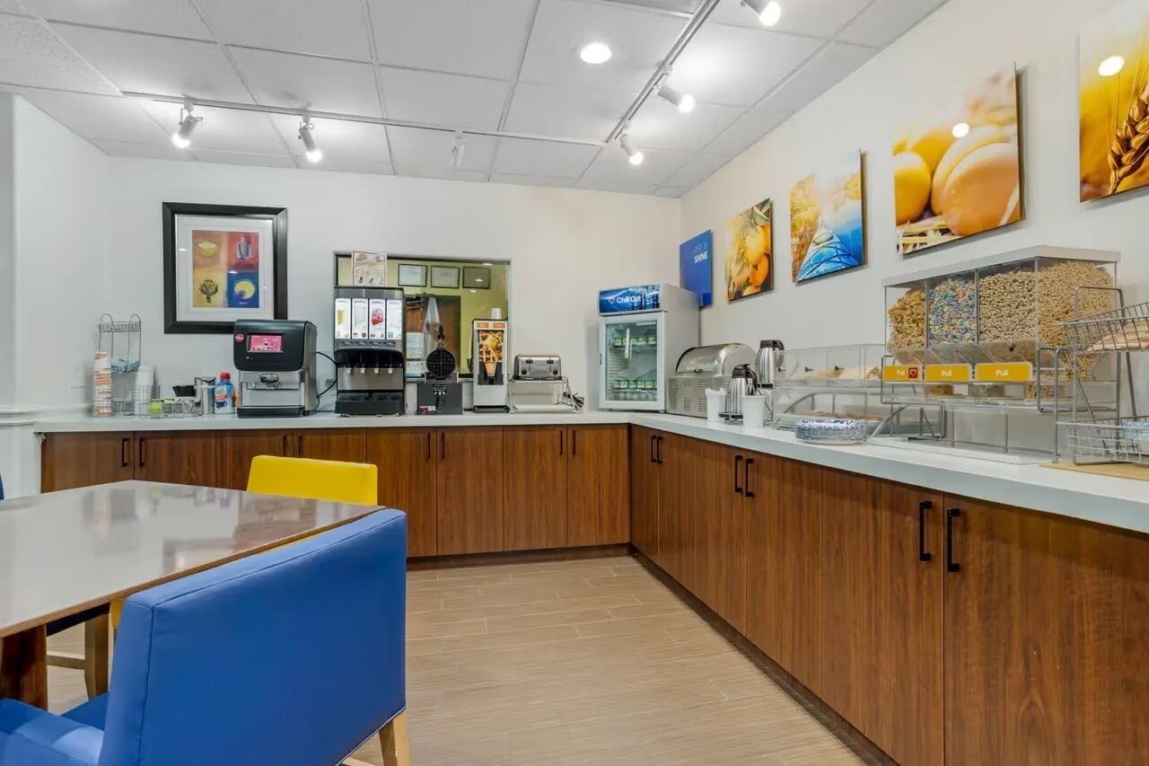 A breakfast area with a counter, seating, and various food service equipment.