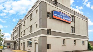 Ein Howard Johnson Inn Gebäude mit einer auffälligen Schautafel, zahlreichen Fenstern und einer glatten Fassade.