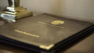A book titled "London Lodge Hotel" with a gold embossed logo.
