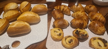 A variety of baked goods displayed on a wooden table.