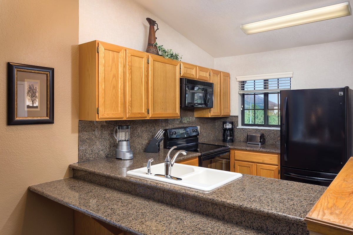 full-sized fridge, microwave, stovetop, coffee/tea maker