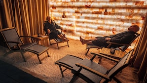 A room with two lounge chairs, a small table, and a wall with a unique textured pattern. - Arroyo Pinion Hotel, an Ascend Collection Hotel (Sedona)