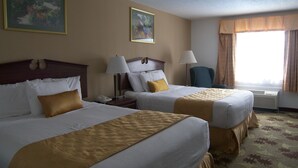 A hotel room with two beds, a nightstand with a lamp, a chair, and a window with curtains. - Baymont by Wyndham Mount Vernon Renfro Valley (Mount Vernon)