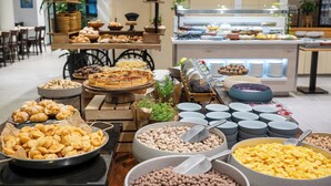 A buffet with various food items and a seating area with tables and chairs. - Ein Gev Holiday Resort (Emek HaYarden)