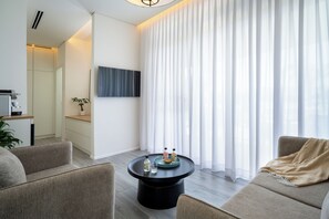 Family Villa | Living area | 42-inch LCD TV with cable channels, TV - Ein Gev Holiday Resort (Emek HaYarden)