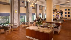 A spacious hotel lobby with high ceilings, large windows, and a central reception area. - Jaypee Vasant Continental (New Delhi)