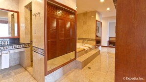 A modern bathroom with a marble floor, a wooden vanity, a bathtub, and a large mirror.