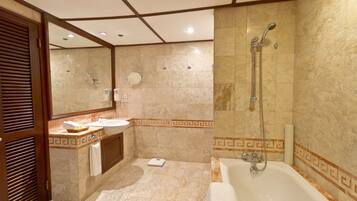 A modern bathroom with a bathtub, a vanity with a sink, and a large mirror.