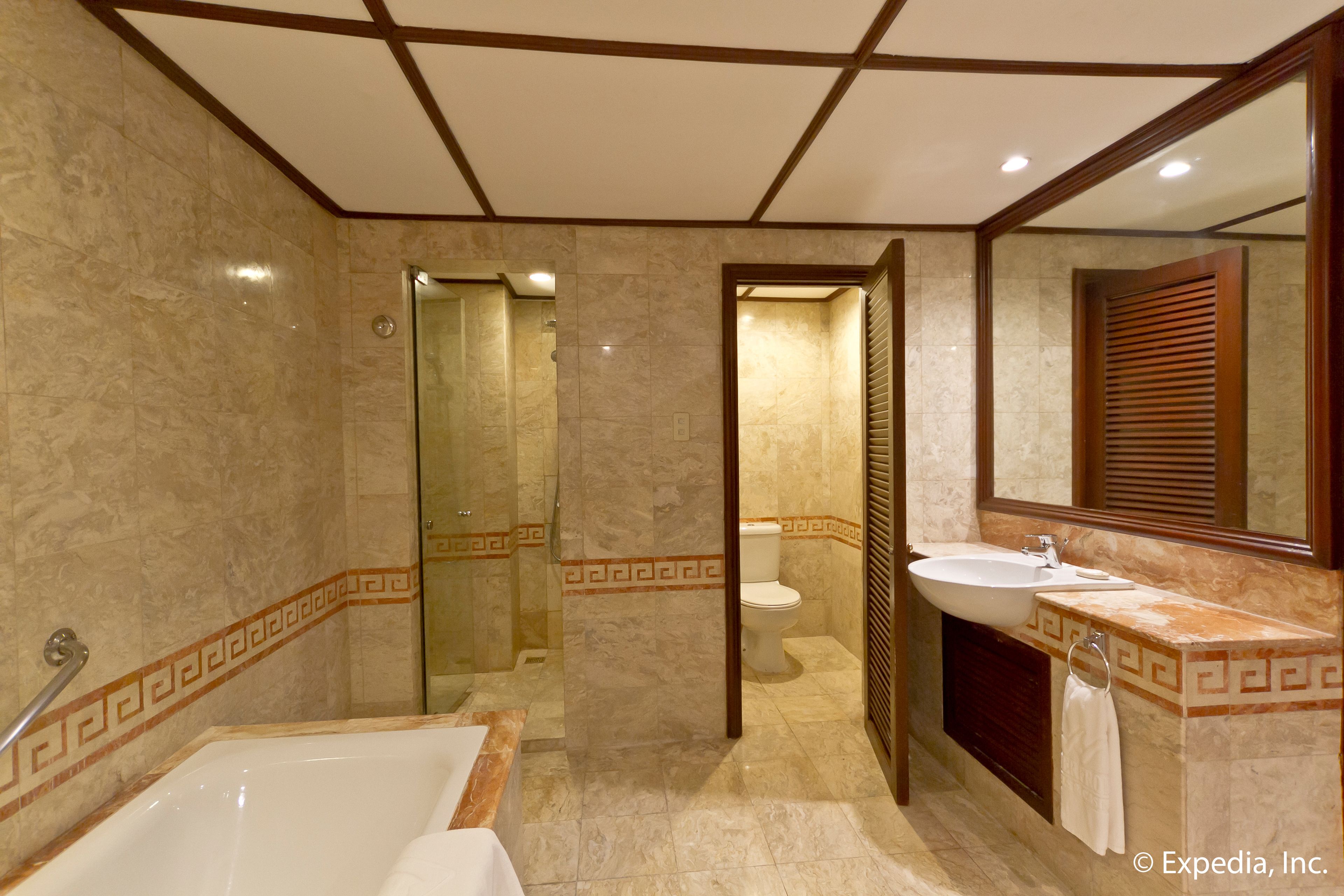 A bathroom with a bathtub, a sink, and a toilet.