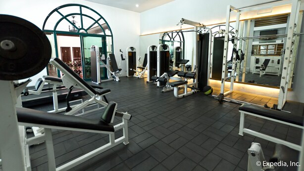 A gym with various exercise equipment, including treadmills, weight machines, and free weights. - Waterfront Airport Hotel & Casino (Lapu-Lapu)