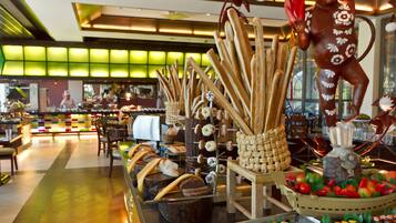 A buffet with various food items and a decorative monkey statue.