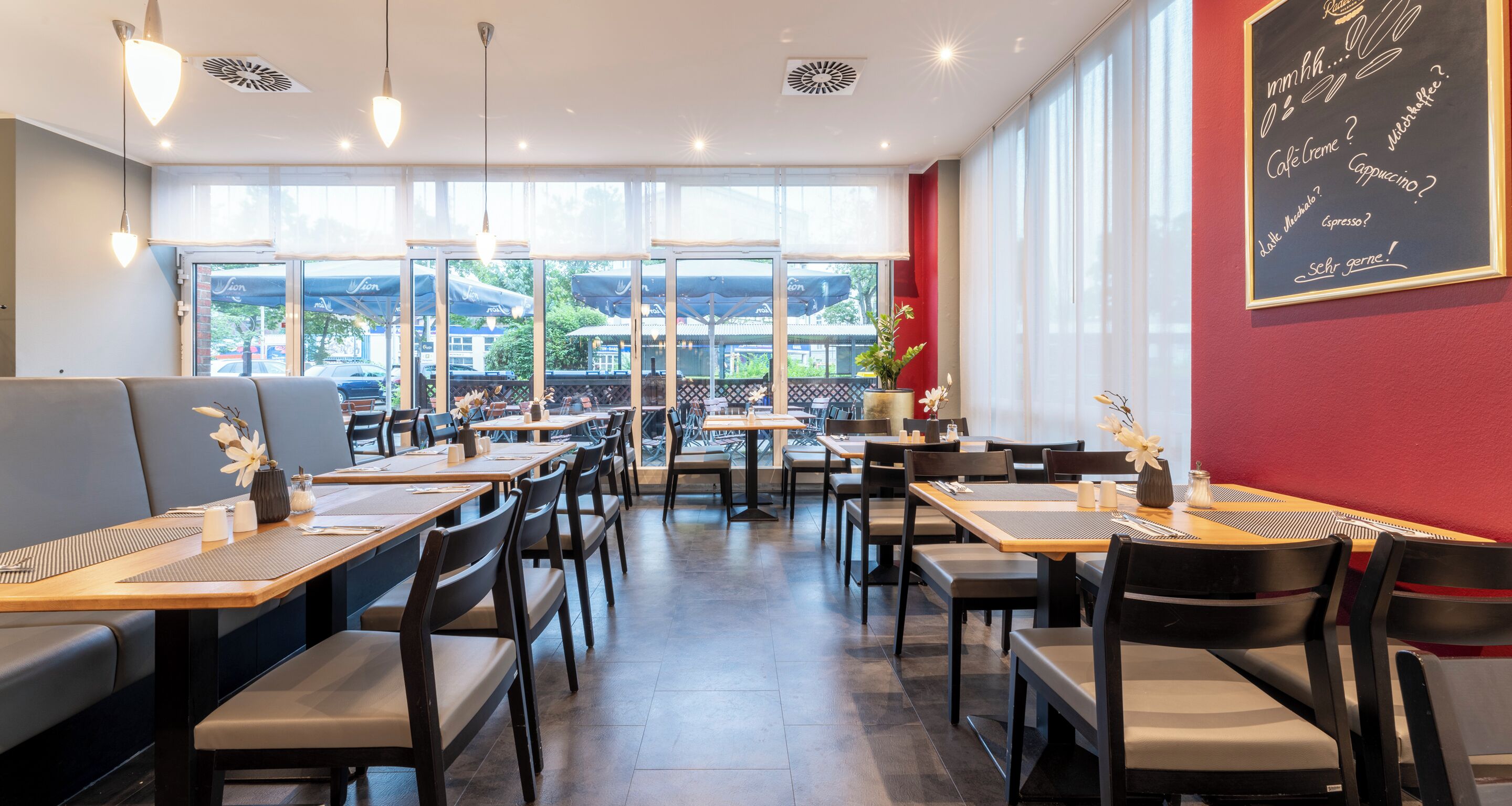 A restaurant with tables and chairs arranged for dining.
