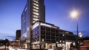A modern hotel with a prominent 'Pullman' sign, featuring a large entrance and a tall adjacent building. - Pullman London St Pancras (London)