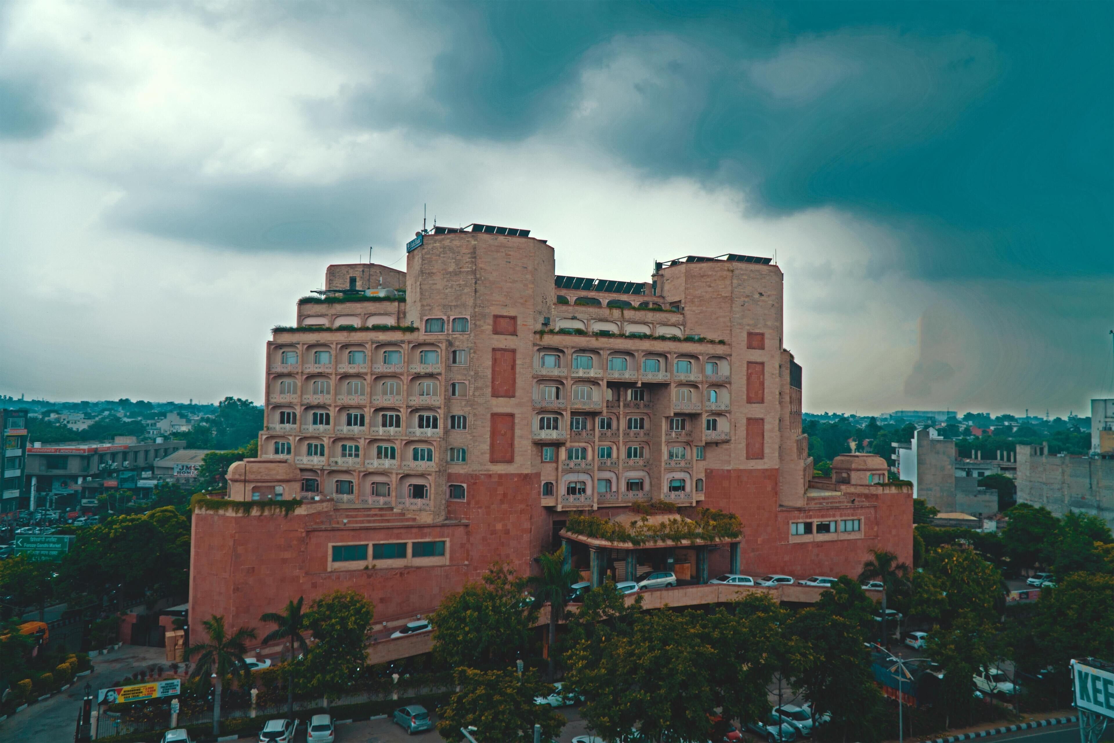 A large, multi-story building with a unique architectural design, featuring multiple balconies and a central courtyard.