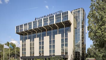 Een modern hotel met een opvallende naam op de gevel, grote ramen en een plat dak.