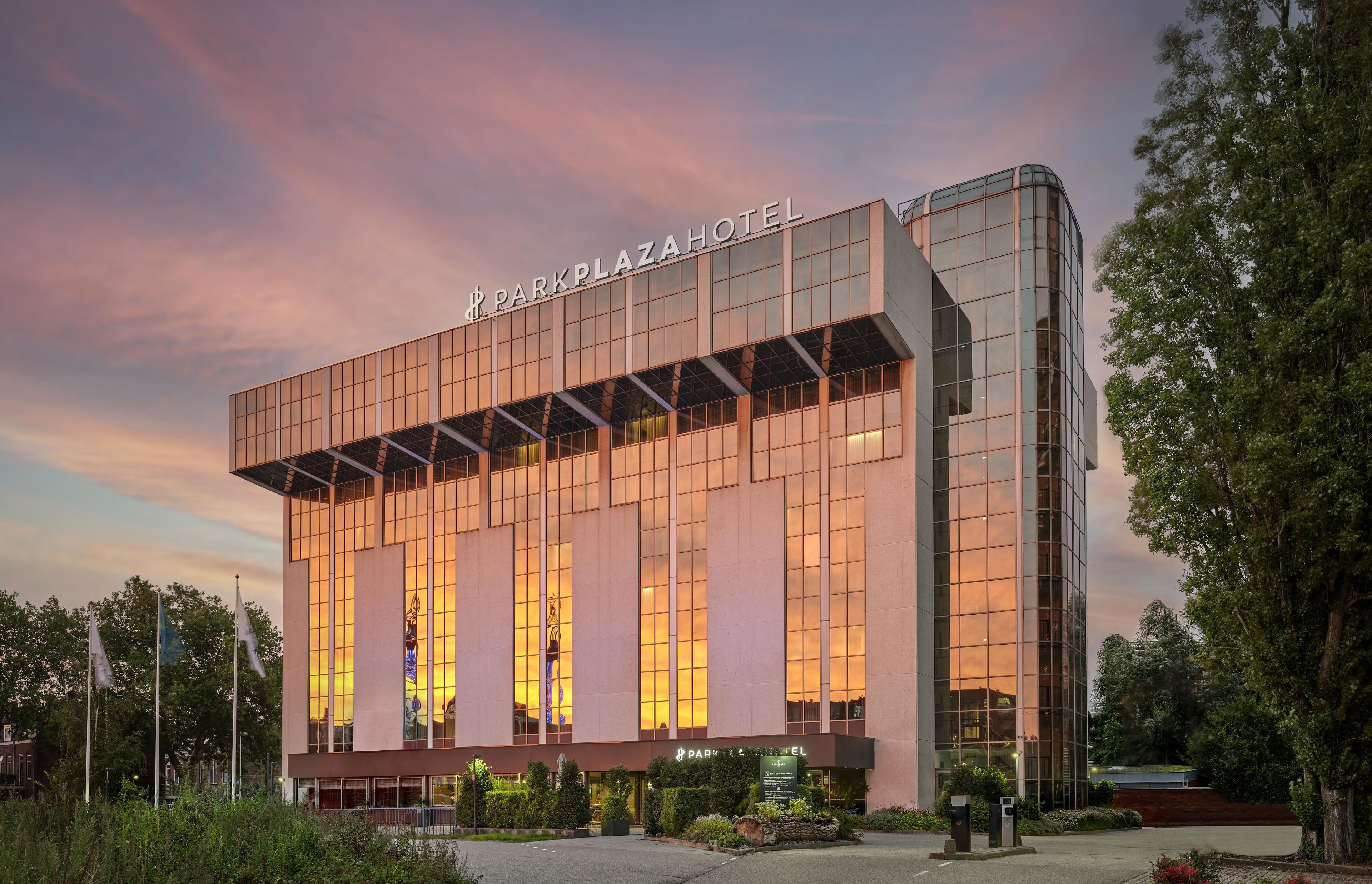A modern hotel building with a prominent sign reading 'PARKPLAZA HOTEL'.