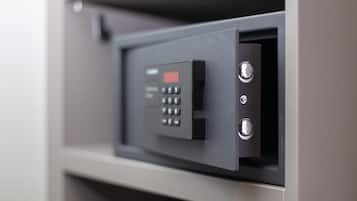 A secure, metallic keypad lock on a gray door, likely for a hotel room or office.