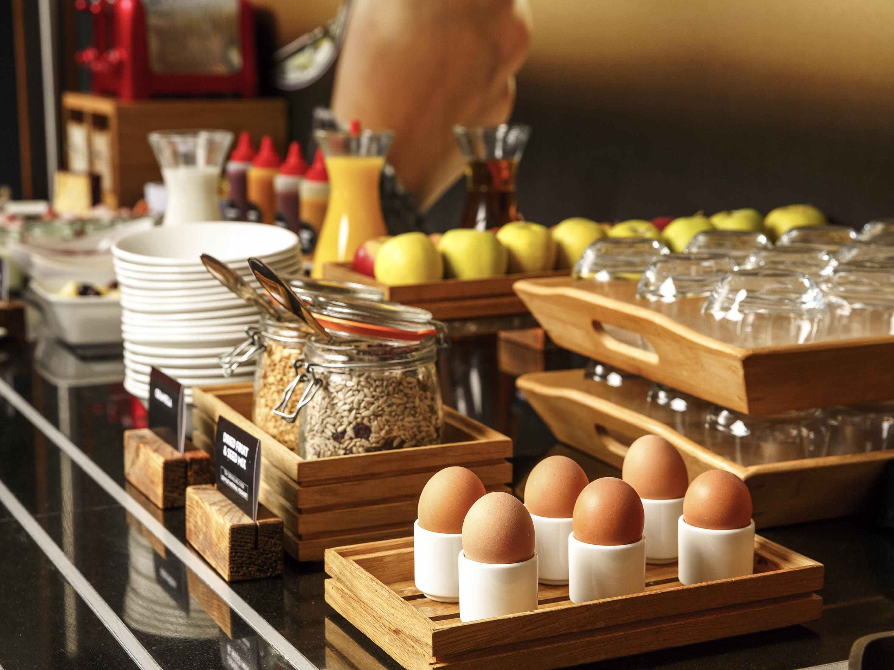 A breakfast buffet with various food items and condiments.