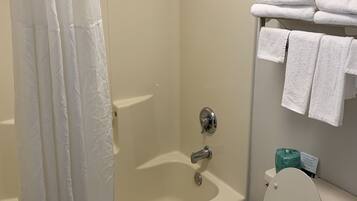 A bathroom with a shower, toilet, and towel rack.