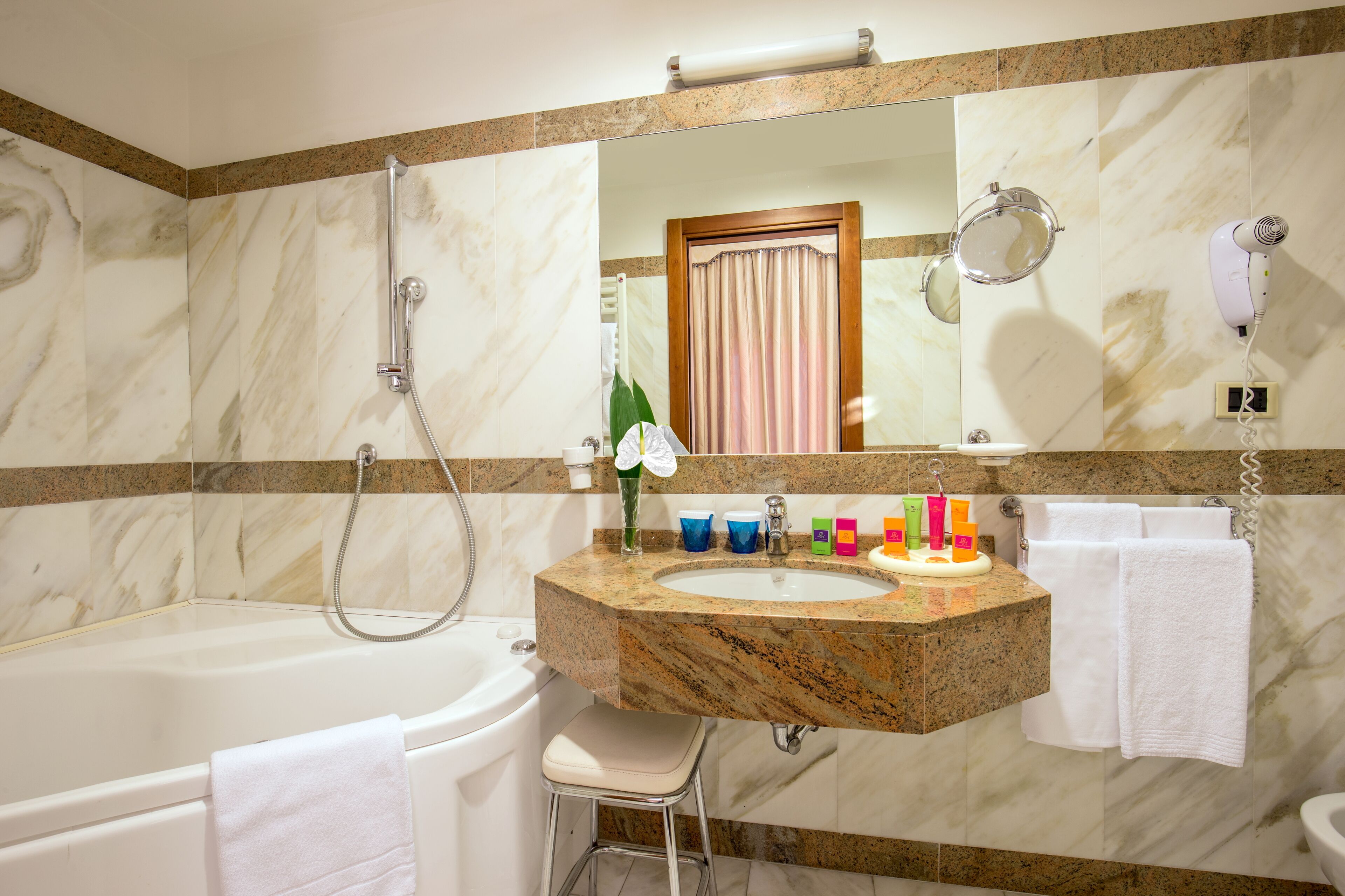 designer toiletries, hair dryer, bathrobes, slippers