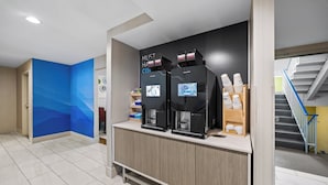 A coffee station with two coffee machines and a counter with a coffee dispenser. - Holiday Inn Express Sunnyvale - Silicon Valley by IHG (Sunnyvale)