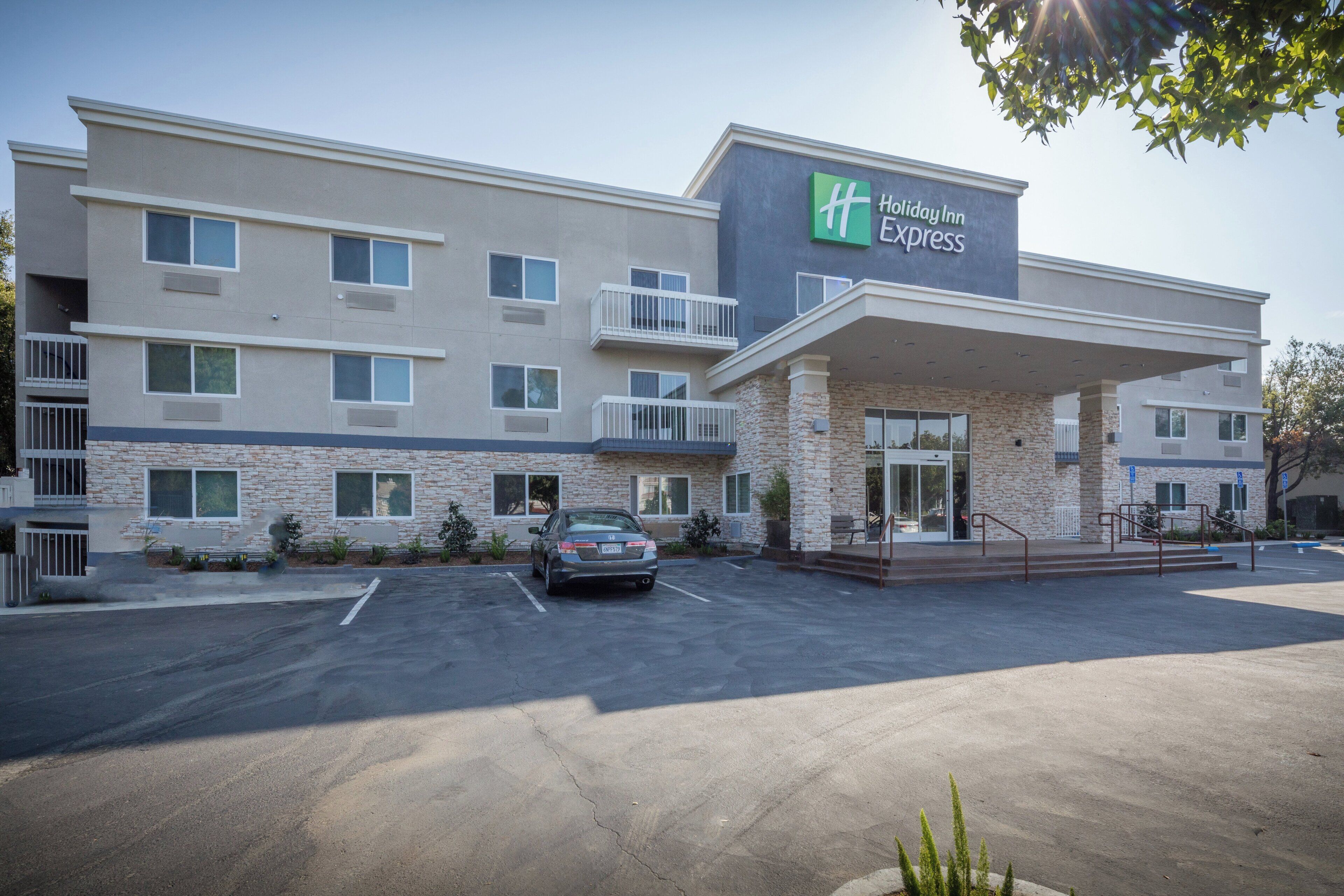 A Holiday Inn Express building with a parking lot in front.