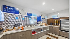 A breakfast buffet area with labeled sections for hot food, cereal, yogurt, eggs, and milk. - Holiday Inn Express Sunnyvale - Silicon Valley by IHG (Sunnyvale)