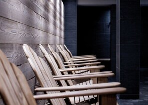 Seating area with chairs aligned against a wall, adjacent to a door.