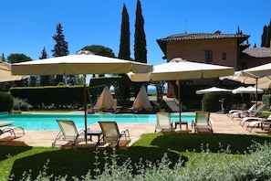 Seasonal outdoor pool, open 9 AM to 7 PM, pool umbrellas, pool loungers