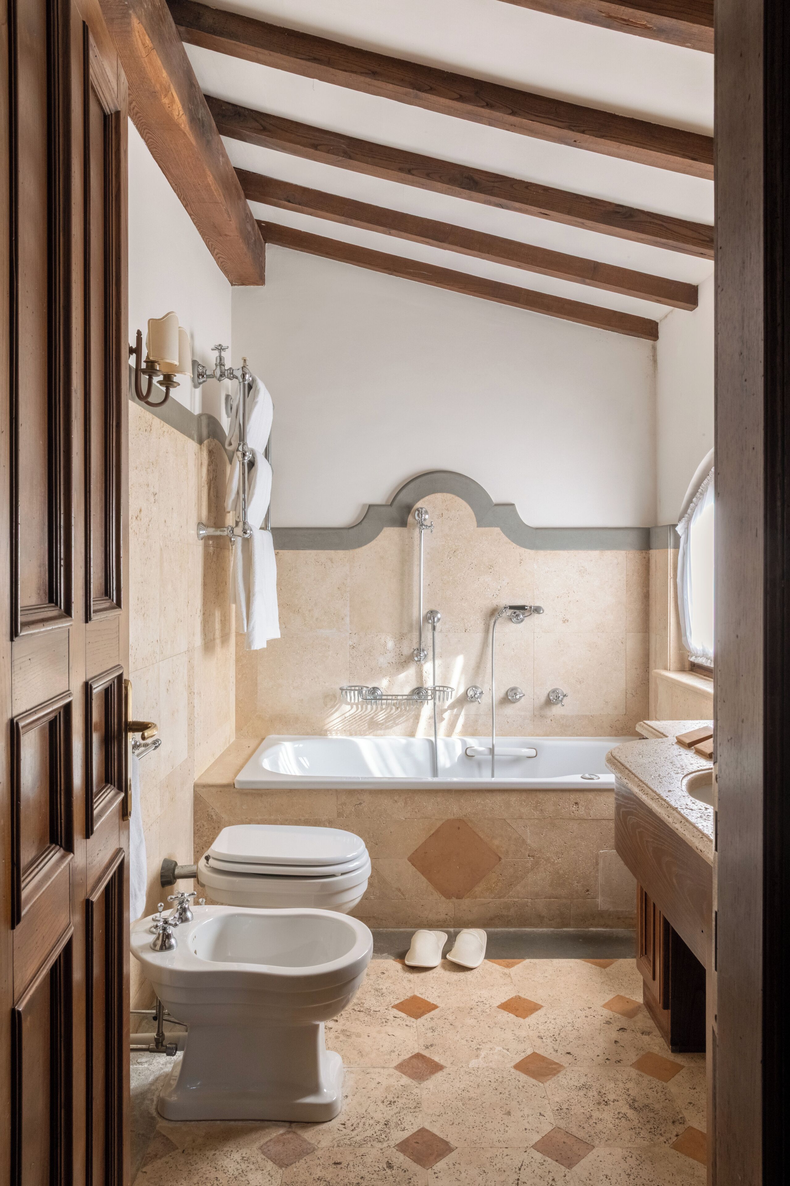 A bathroom with a bathtub, a bidet, and a toilet.