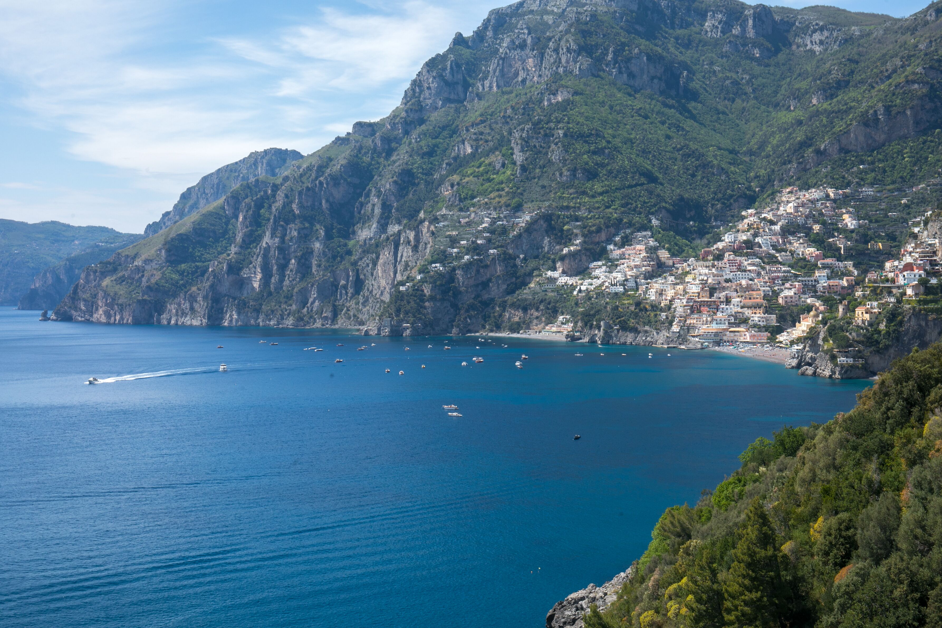 A coastal town with buildings built on steep cliffs overlooking the sea.