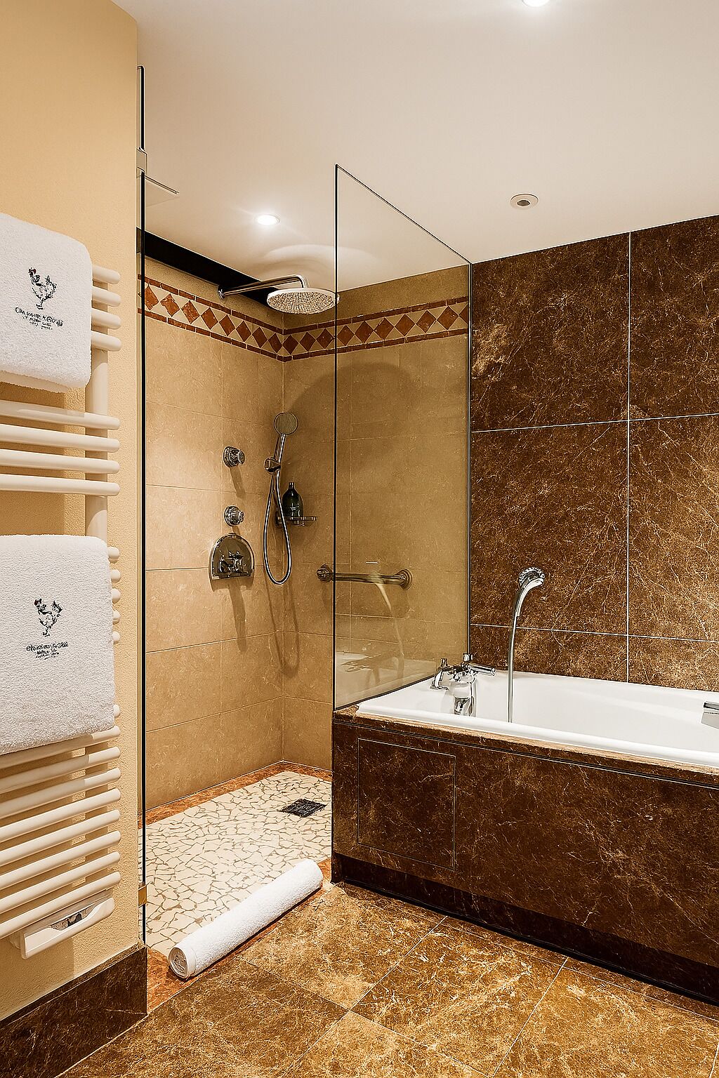 A modern bathroom with a glass-enclosed shower, a freestanding bathtub, and a towel rack with towels.
