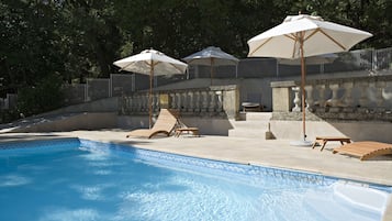 Seasonal outdoor pool, open 8:00 AM to 7:00 PM, pool umbrellas