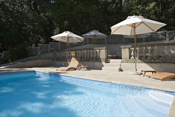 Seasonal outdoor pool, open 8:00 AM to 7:00 PM, pool umbrellas