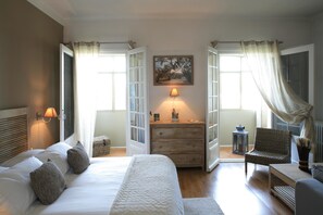 A bedroom with a bed, a dresser, a chair, and a lamp. - La Regalido (Fontvieille)