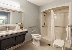 A modern bathroom with a sink, toilet, and walk-in shower. - Robert Treat Hotel (Newark)