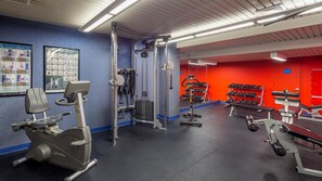 A gym with cardio machines, weightlifting equipment, and dumbbells. - Robert Treat Hotel (Newark)