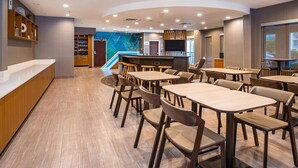 A modern hotel lobby with a reception desk, seating area, and a children's play area. - Springhill Suites By Marriott Orlando Altamonte Springs (Altamonte Springs)