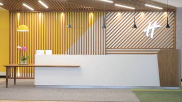 A reception desk with a wooden slat wall, pendant lights, and a potted plant.