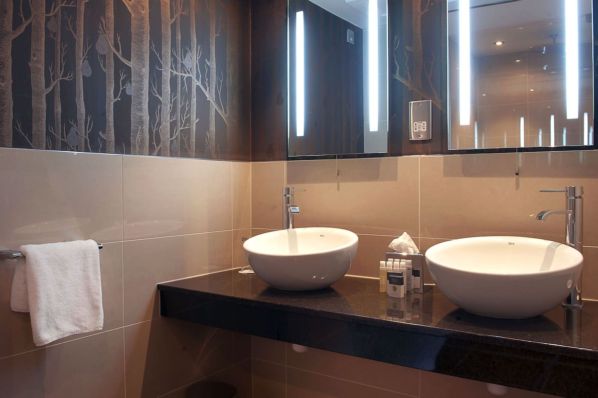 designer toiletries, hair dryer, towels, soap