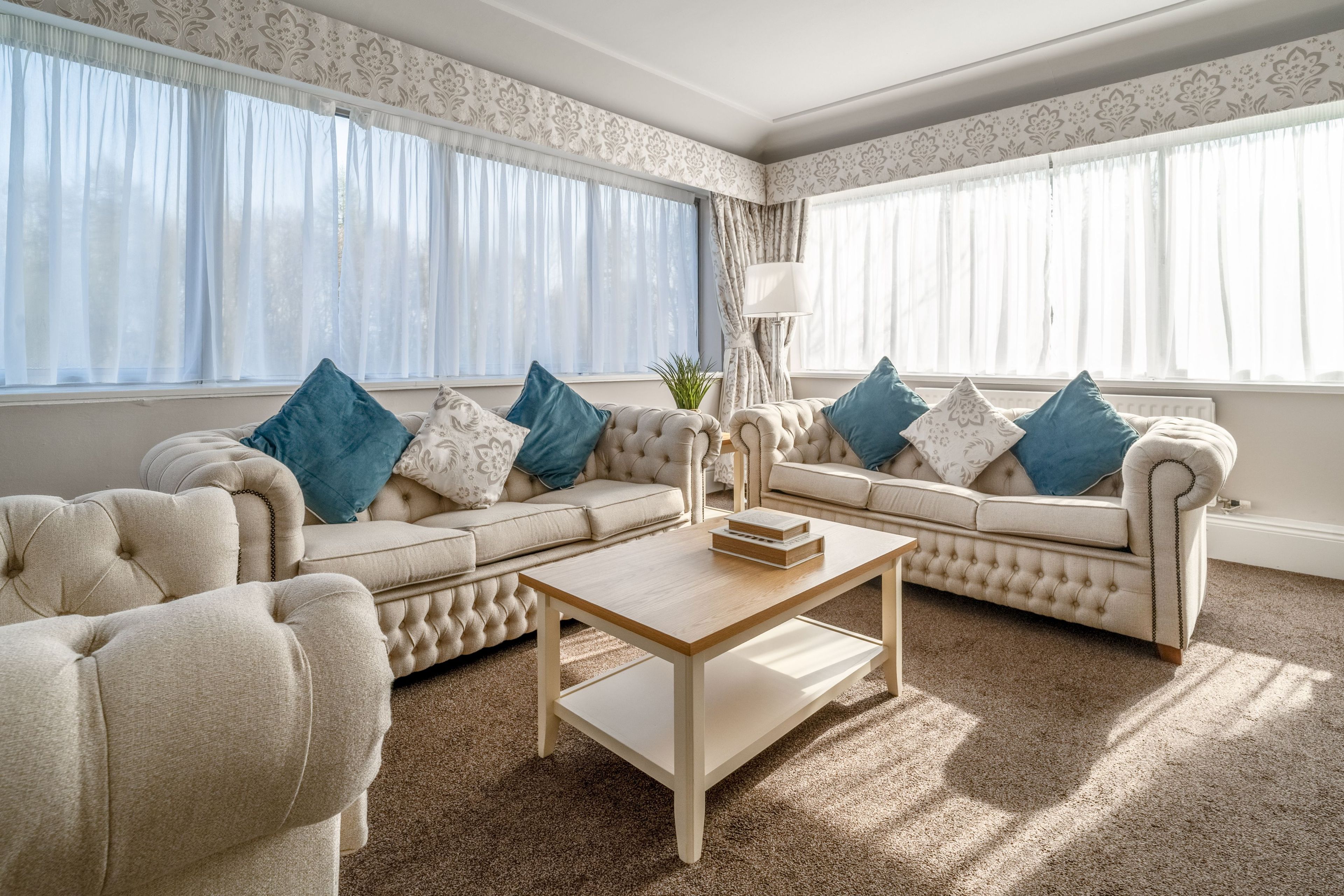 A living room with two sofas, a coffee table, and a lamp.